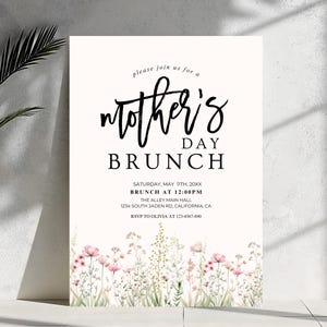 May include: A white invitation with black text for a Mother's Day brunch. The invitation includes the date, time, location, and RSVP information. The background features a watercolor floral design.