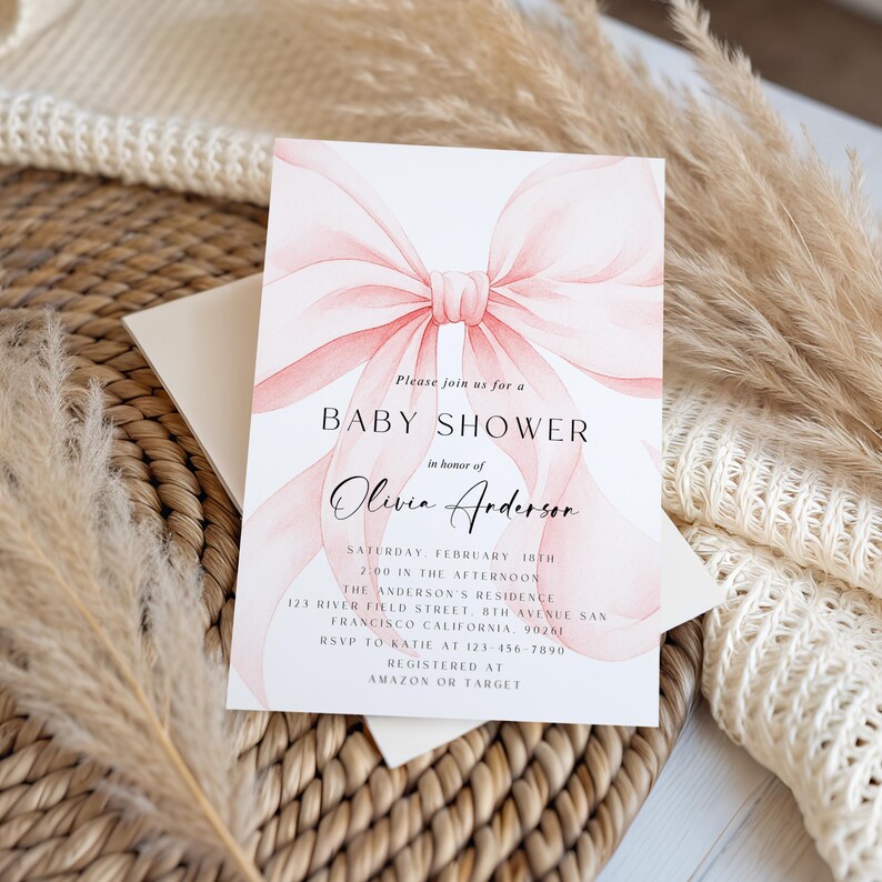 May include: A baby shower invitation featuring a watercolor-style pink bow. The invitation includes the text "Baby Shower" and details for Olivia Anderson's shower, including the date, time, and location.