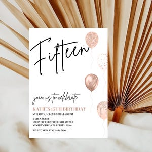 May include: A white invitation card with black text that reads "Fifteen" and "join us to celebrate KATIE'S 15TH BIRTHDAY". The card is decorated with rose gold balloons and confetti.