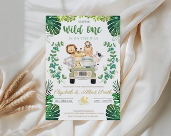 May include: Baby shower invitation with a safari theme. The invitation features a green jeep filled with cartoon animals, including a lion, giraffe, and zebra. Text includes "A Little Wild One Is On The Way" and event details for Elizabeth & Albert Smith.