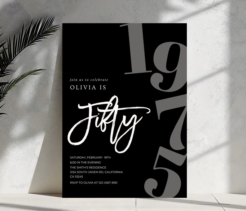 May include: A black and white invitation for Olivia's 50th birthday. The design features the word "Fifty" in elegant script, with the year "1975" in large gray numbers. Additional text includes event details: date, time, location, and RSVP information.