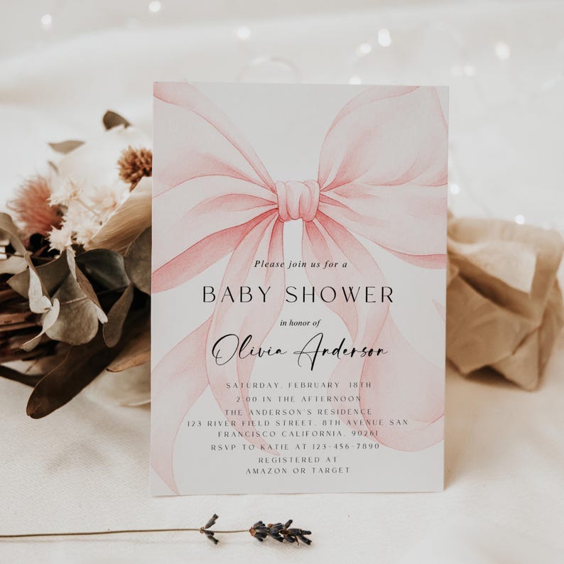 May include: A baby shower invitation with a watercolor-style pink bow design. The invitation includes the text "Baby Shower" and details for Olivia Anderson's shower, including date, time, and location.