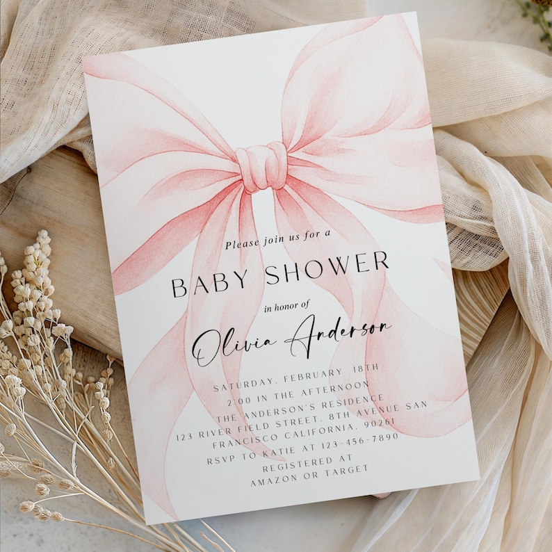 May include: Baby shower invitation with a watercolor pink bow design. The invitation includes the text "Baby Shower" and details for Olivia Anderson's shower, including date, time, location, and RSVP information.