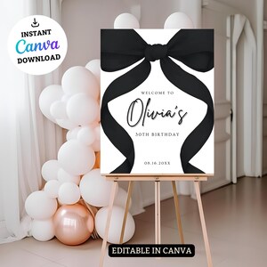 May include: A white welcome sign with a black bow on top. The sign says "Welcome to Olivia's 50th Birthday 08.16.20XX".