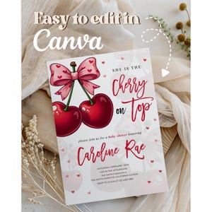 May include: Baby shower invitation featuring a pair of red cherries with a pink bow. The text "She is the Cherry on Top" is displayed in a handwritten font. The invitation includes details for Caroline Rae's baby shower, with the text "Easy to edit in Canva".