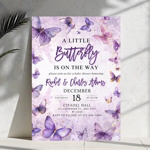 May include: A baby shower invitation featuring a watercolor design with purple butterflies. The text reads "A Little Butterfly Is On The Way" with the names Rachel & Charles Adams, date, time, and location.