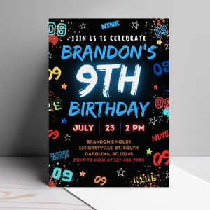 May include: A black birthday invitation with colorful paint splatters and the text "Join us to celebrate Brandon's 9th Birthday" in white and blue. The date and time are listed as "July 23, 2 PM". The invitation also includes the address "Brandon's House, 123 Greyville St. South Carolina, SC 10245" and the RSVP information "RSVP to Mom at 123-456-7890".