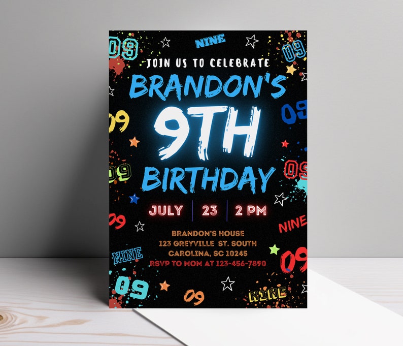May include: A black birthday invitation with colorful paint splatters and the text "Join us to celebrate Brandon's 9th Birthday" in white and blue. The date and time are listed as "July 23, 2 PM". The invitation also includes the address "Brandon's House, 123 Greyville St. South Carolina, SC 10245" and the RSVP information "RSVP to Mom at 123-456-7890".