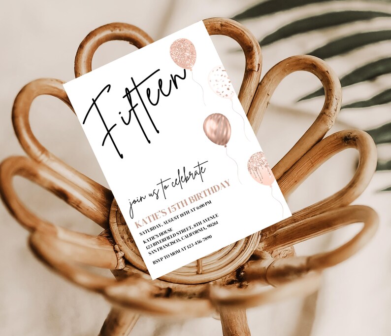 May include: A white invitation card with the word "Fifteen" in black script. The card is decorated with rose gold balloons and confetti. The text on the card reads "Join us to celebrate Katie's 15th Birthday, Saturday, August 15th at 6:00 PM, Kate's House, 121 Riverfred Street, 5th Avenue, San Francisco, California, 90264, RSVP to Mom at 123-456-7890."
