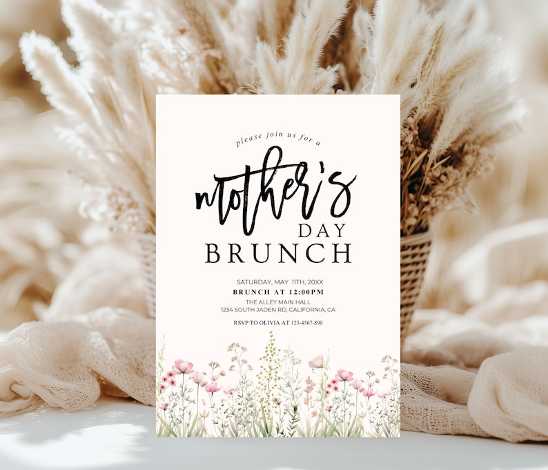 May include: White invitation card with black text that reads "Please join us for a mother's day brunch" with the date and time of the event, "Saturday, May 11th, 20XX, Brunch at 12:00PM", the location, "The Alley Main Hall, 1234 South Jaden Rd, California, CA", and the RSVP information, "RSVP to Olivia at 123-4567-890". The bottom of the card features a watercolor illustration of pink and white flowers.