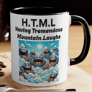 May include: White ceramic coffee mug with a black rim and handle. The mug features a cartoon image of mountains with faces laughing. The text "H.T.M.L. Having Tremendous Mountain Laughs" is printed on the mug.