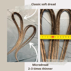 May include: Two sets of dreadlocks, one set is labeled "Classic soft dread" and the other is labeled "Microdread 2-3 times thinner". The dreadlocks are brown and blonde and are measured with a ruler. The ruler shows that the classic dreadlocks are about 1 inch thick and the micro dreadlocks are about 1/3 inch thick.