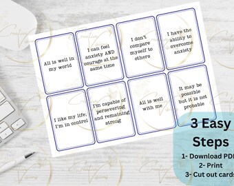 May include: Eight printable affirmation cards with blue borders and white backgrounds. The cards feature positive affirmations such as "All is well in my world" and "I have the ability to overcome anxiety". The cards are part of a three-step process to download, print, and cut out the cards.
