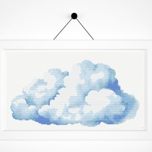 May include: A framed cross-stitch design of a blue watercolor cloud on a white background.