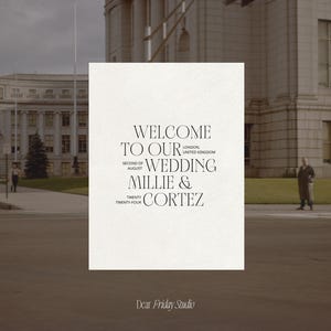 May include: A wedding invitation with a white background and black text. The text reads "Welcome to our wedding Millie & Cortez, Second of August, Twenty Twenty Four, London, United Kingdom". The invitation is on a table in front of a building.