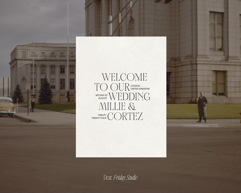 May include: A wedding invitation with a white background and black text. The text reads "Welcome to our wedding Millie & Cortez, Second of August, Twenty Twenty Four, London, United Kingdom". The invitation is on a table in front of a building.