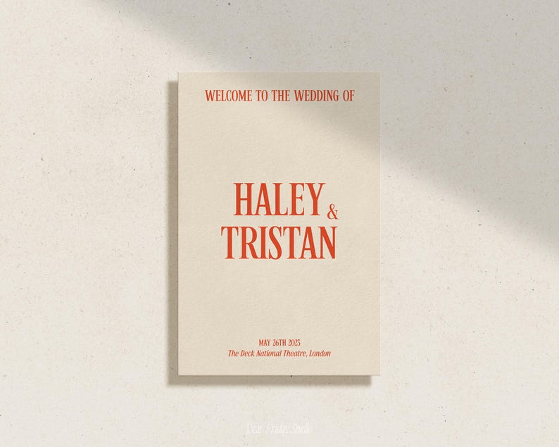 May include: A wedding announcement card with a cream background and red text. The text reads "Welcome to the wedding of Haley & Tristan, May 26th 2025, The Deck National Theatre, London."