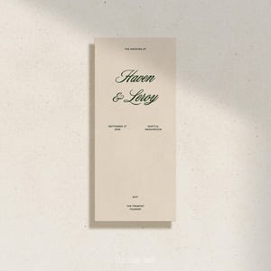 May include: A wedding invitation with a cream background and green text. The text reads "The Wedding of Haven & Leroy" with the date "September 17, 2023" and location "Seattle, Washington". The bottom of the invitation reads "8:27 The Fremont Foundry".