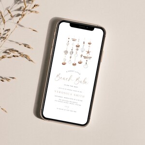 May include: A digital invitation for a baby shower with a watercolor illustration of a seashell mobile. The text reads "A Sweet Little Beach Babe Is On The Way" and includes the name Veronica Smith, the date and time of the event, and the location.