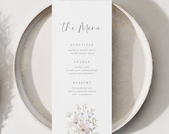 May include: A wedding menu card with a floral illustration. The menu includes appetizers, entree, and dessert options. The text reads "the Menu", "APPETIZER", "butternut squash ravioli", "italian garden salad", "ENTREE", "grilled steak", "piccata and stuffed pepper", "pasta with meatballs", "DESSERT", "the wedding cake", "vanilla chocolate mousse", "with strawberries".