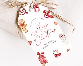 May include: White gift tag with red and brown watercolor illustrations of gingerbread cookies, candy canes, and Christmas trees. The text reads "Wishing you a sweet Merry Christmas with love Anderson Family".