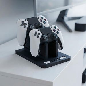 May include: A black plastic dual controller charging stand featuring two white and black game controllers docked in place. The base of the stand has the name MIKE embossed in white lettering on the front edge, providing a stable mount for gaming.