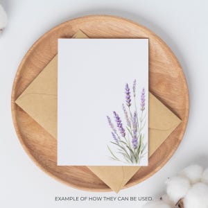 May include: A white card with a watercolor lavender design, resting on a brown envelope and a wooden plate. The text at the bottom reads, "EXAMPLE OF HOW THEY CAN BE USED."