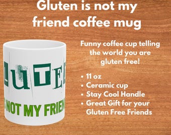 Puede incluir: Taza de café de cerámica blanca con texto verde que dice "Gluten is not my friend". La taza tiene una capacidad de 11 onzas y un asa que se mantiene fría.