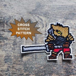 Puede incluir: Patrón de punto de cruz que representa un guerrero pixelado con una espada. El guerrero está representado en tonos marrones, negros y rojos. También se ven los textos "CROSS STITCH PATTERN" y "PDF DOWNLOAD".