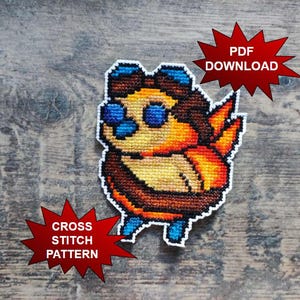 May include: A cross-stitch pattern of a cartoon character with blue goggles, orange wings, and a brown body. The text "PDF DOWNLOAD" and "CROSS STITCH PATTERN" are in red starbursts.