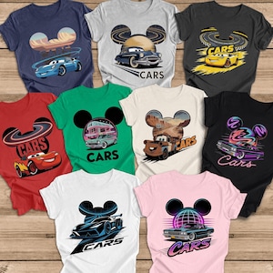 May include: A selection of t-shirts with car-themed graphics. Each tee displays a unique car illustration, with the word "CARS" included. The shirts are available in a range of colours, such as navy, grey, red, green, white, black, and pink.