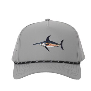 May include: Gray mesh trucker hat with a black rope trim and an embroidered image of a blue and orange swordfish.