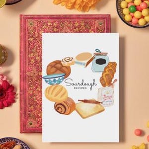 May include: A white card with a circle of illustrated sourdough bread, rolls, and a bowl of dough. The text "Sourdough Recipes" is in the center of the circle.
