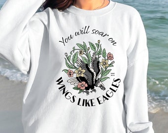 Peut inclure: Sweat-shirt blanc avec un motif floral et un aigle avec le texte "You will soar on wings like eagles".