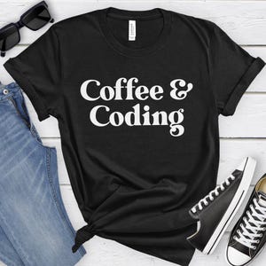 May include: Black t-shirt with white text that reads "Coffee & Coding".
