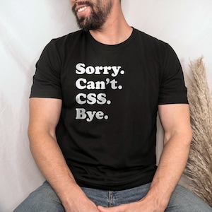 May include: A black t-shirt with the text "Sorry. Can't. CSS. Bye." printed in white.