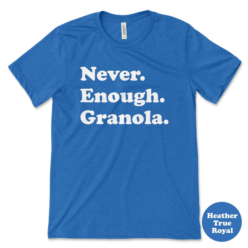 May include: A blue t-shirt with white text that reads "Never. Enough. Granola."
