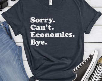 May include: A dark blue t-shirt with white text that reads "Sorry. Can't. Economics. Bye."