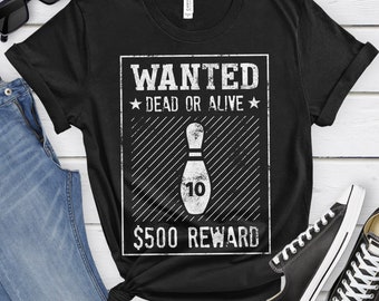 May include: Black t-shirt with a white graphic of a wanted poster for a bowling pin. The poster says "WANTED DEAD OR ALIVE" and "$500 REWARD".