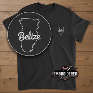 May include: Black t-shirt with an embroidered outline of Belize and the word "Belize" in white script. A larger, circular close-up of the design is on the left. The shirt also has a small embroidered Belize outline on the right chest.
