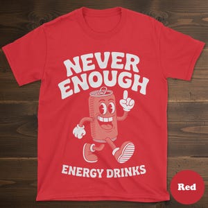 May include: Red t-shirt with the text "NEVER ENOUGH ENERGY DRINKS" in white. The shirt features a cartoon illustration of a smiling energy drink can with arms and legs, pointing upwards.