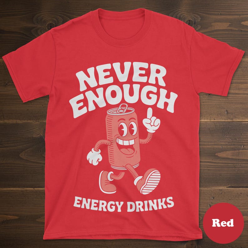 May include: Red t-shirt with the text "NEVER ENOUGH ENERGY DRINKS" in white. The shirt features a cartoon illustration of a smiling energy drink can with arms and legs, pointing upwards.
