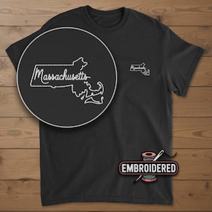 May include: Black t-shirt with a white embroidered outline of the Massachusetts state map and the word "Massachusetts". A close-up shows the embroidery detail. The word "EMBROIDERED" is printed on the bottom.