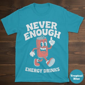 May include: A tropical blue t-shirt with the words "NEVER ENOUGH ENERGY DRINKS" in white. The shirt features a cartoon image of a red soda can with a smiling face, arms, legs, and red sneakers.