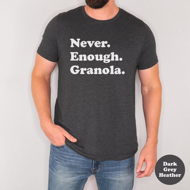 May include: A dark grey heather t-shirt with the text "Never. Enough. Granola." printed in white.