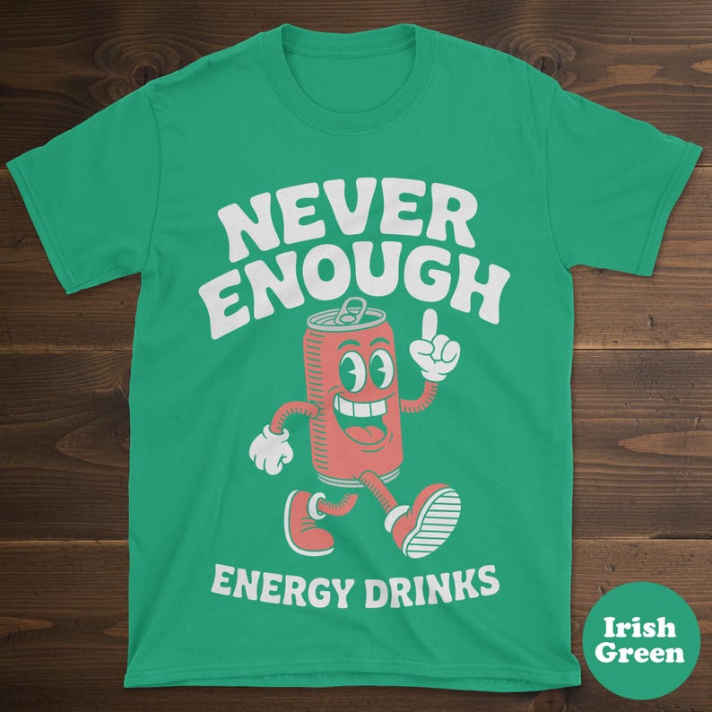 May include: Irish green t-shirt with the words "NEVER ENOUGH ENERGY DRINKS" in white. A cartoon soda can character with a smiling face and red color is featured in the center, pointing upwards.