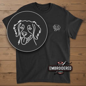 May include: Black t-shirt with a white embroidered outline of a dog's face on the chest and a larger version in a circular patch. The word "EMBROIDERED" is displayed on a pink and white label.
