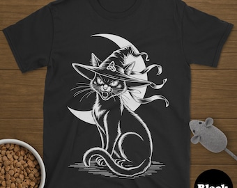 May include: Black t-shirt featuring a white illustration of a black cat wearing a witch hat, set against a crescent moon. The cat has an angry expression. A bowl of cat food and a toy mouse are in the image.