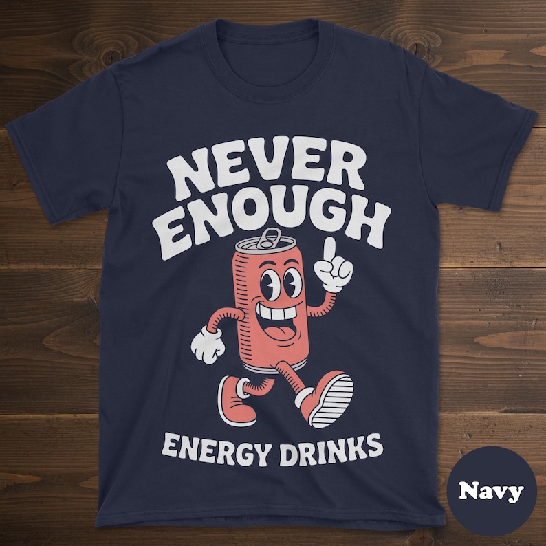 May include: Navy blue t-shirt with the words "NEVER ENOUGH ENERGY DRINKS" in white. The shirt features a cartoon image of a smiling energy drink can with arms and legs, pointing upwards.