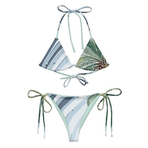Puede incluir: Un bikini estampado en azul y verde con tirantes ajustables. La parte superior es de estilo triangular y la inferior es de corte atrevido.